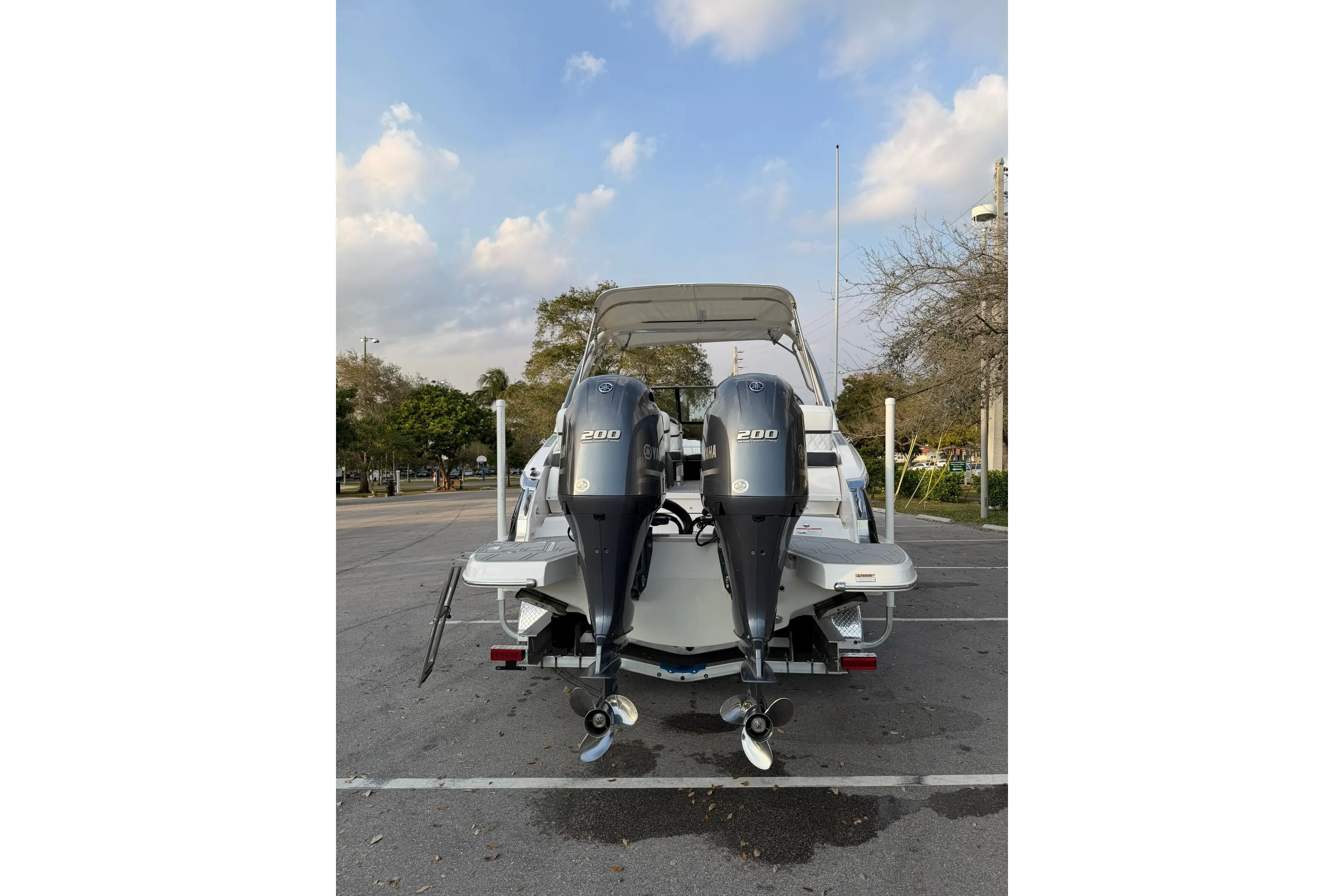 2019 Regal 29 OBX boat with dual 200 horsepower outboard engines, parked outdoors.