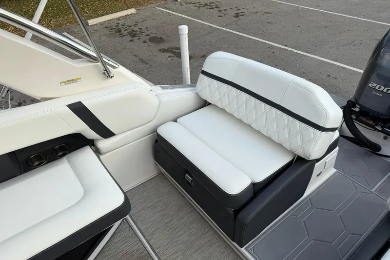  Yacht Photos Pics 2019 Regal 29 OBX boat interior with white cushioned seating and Yamaha 200 engine.