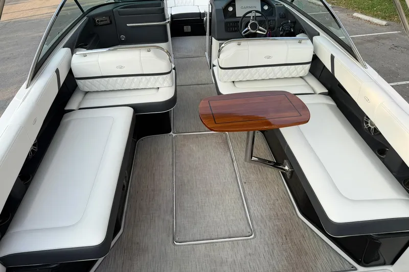  Yacht Photos Pics 2019 Regal 29 OBX boat interior with white seating and wooden table.