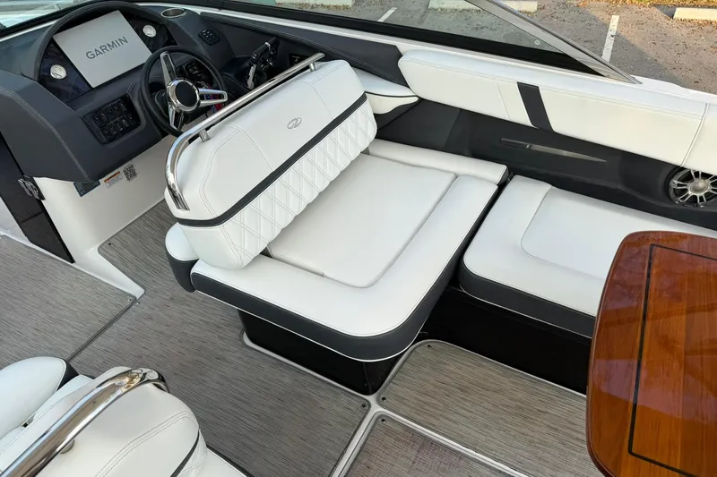  Yacht Photos Pics 2019 Regal 29 OBX boat interior with white seating and Garmin navigation system.
