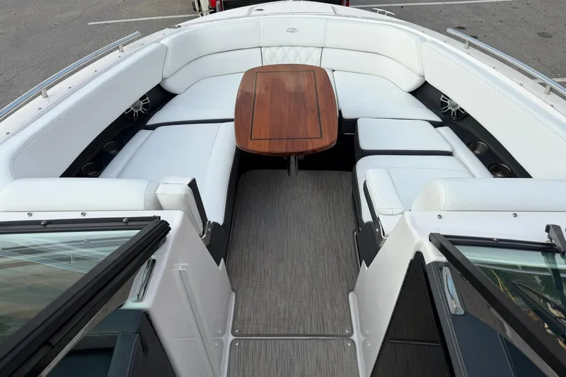  Yacht Photos Pics 2019 Regal 29 OBX boat interior with white seating and wooden table.