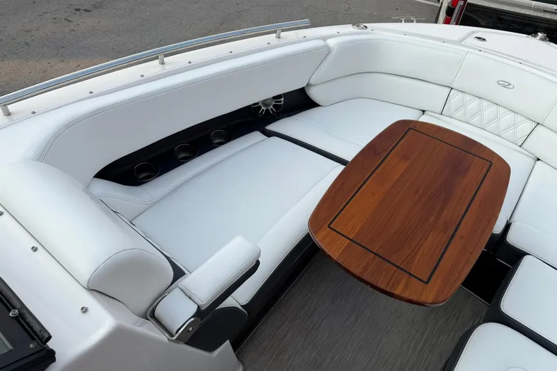  Yacht Photos Pics Luxurious seating area on 2019 Regal 29 OBX boat with elegant wooden table.