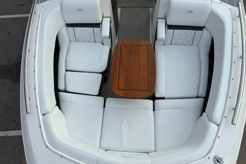  Yacht Photos Pics Luxurious 2019 Regal 29 OBX boat interior with white seating and wooden table.
