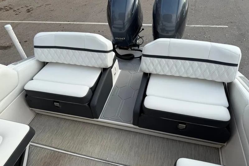  Yacht Photos Pics 2019 Regal 29 OBX boat interior with white cushioned seating and dual outboard motors.
