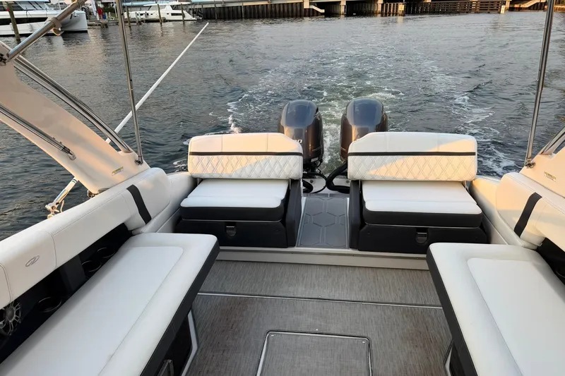  Yacht Photos Pics 2019 Regal 29 OBX boat interior with cushioned seating and twin outboard motors.