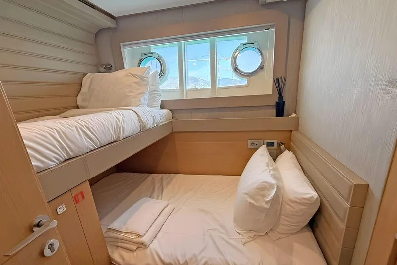 M/y Ilav Yacht Photos Pics Cozy cabin with bunk beds on 2011 Ferretti Yachts 800, featuring porthole windows.