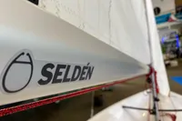 Close-up of 2023 Beneteau First 14 sailboat with Selden branding on the sail.