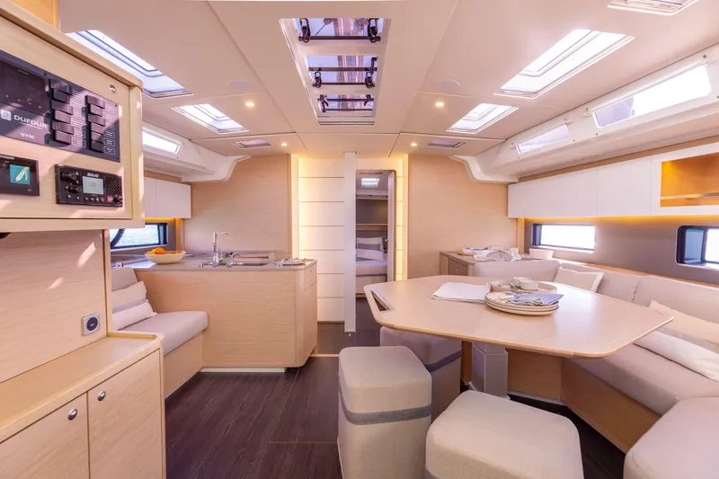  Yacht Photos Pics Luxurious interior of 2025 Dufour 48 yacht with modern kitchen and dining area.