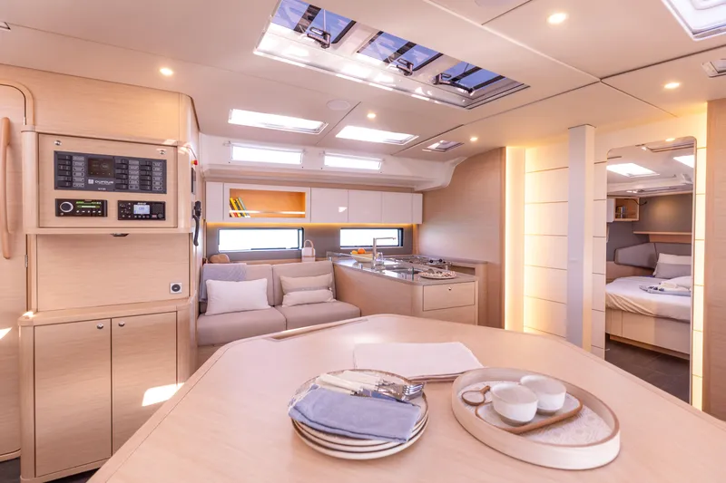  Yacht Photos Pics Luxurious interior of 2025 Dufour 48 yacht with modern kitchen and cozy seating area.