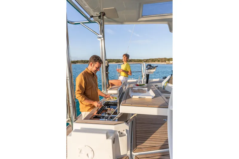  Yacht Photos Pics Two people enjoying a meal on a 2025 Dufour 48 yacht deck.