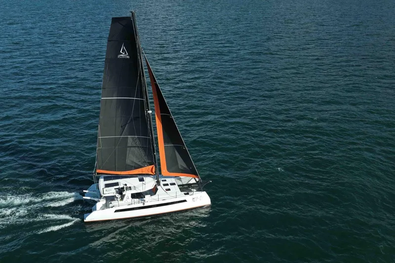  Yacht Photos Pics Sailing catamaran Balance 502, 2027 model, gliding on open sea with black and orange sails.
