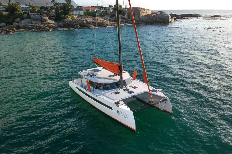  Yacht Photos Pics Sailing catamaran Balance 502, 2027 model, cruising near rocky coastline.