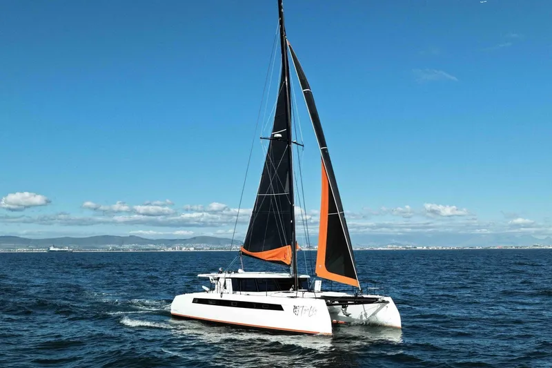  Yacht Photos Pics Sailing catamaran Balance 502, 2027 model, gliding on open sea under clear blue sky.