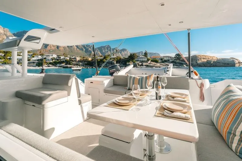  Yacht Photos Pics Luxurious Balance 502 yacht interior with dining setup, scenic coastal view, 2027 model.