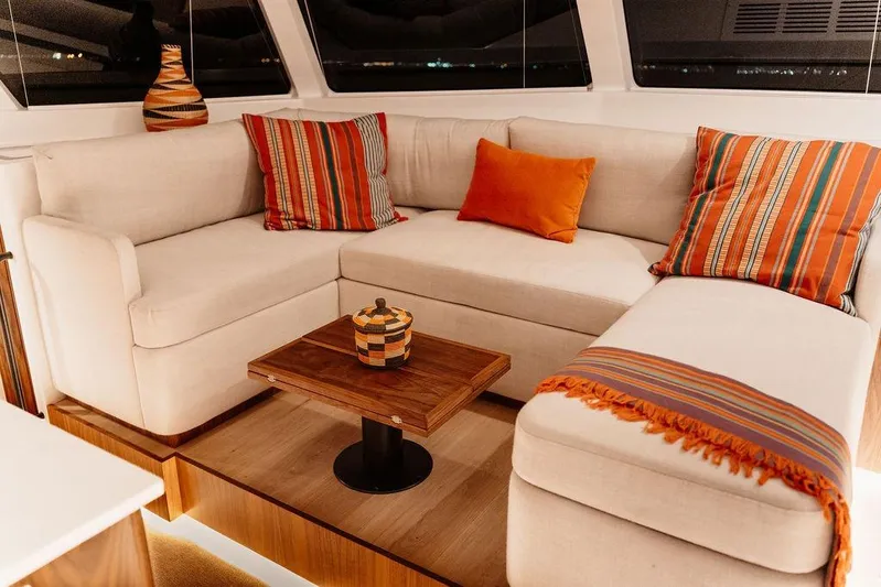  Yacht Photos Pics Luxurious Balance 502 yacht interior with cozy beige sofa, vibrant striped cushions, and wooden table, 2027 model.