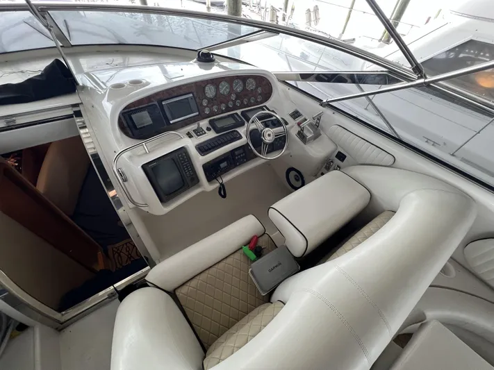  Yacht Photos Pics 1994 Sunseeker Camargue 55 yacht cockpit with luxurious white seating and advanced control panel.
