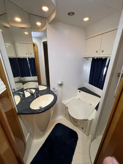 Yacht Photos Pics Luxurious bathroom in a 1994 Sunseeker Camargue 55 yacht, featuring modern fixtures and ample storage.