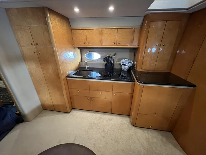  Yacht Photos Pics Luxurious kitchen interior of 1994 Sunseeker Camargue 55 yacht with wood cabinetry.