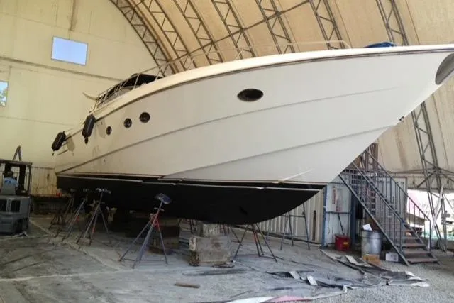 Yacht Photos Pics 1994 Sunseeker Camargue 55 yacht in dry dock for maintenance inside a large shed.