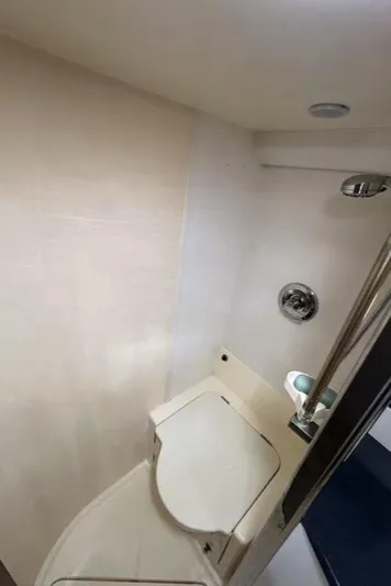  Yacht Photos Pics Bathroom interior of 1994 Sunseeker Camargue 55 yacht, featuring compact design and modern fixtures.