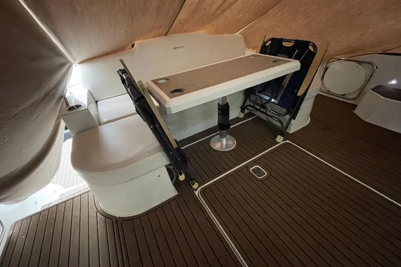 Plan B Yacht Photos Pics Interior of 2012 Cruisers Yachts 48 Cantius with seating and table on wooden deck.
