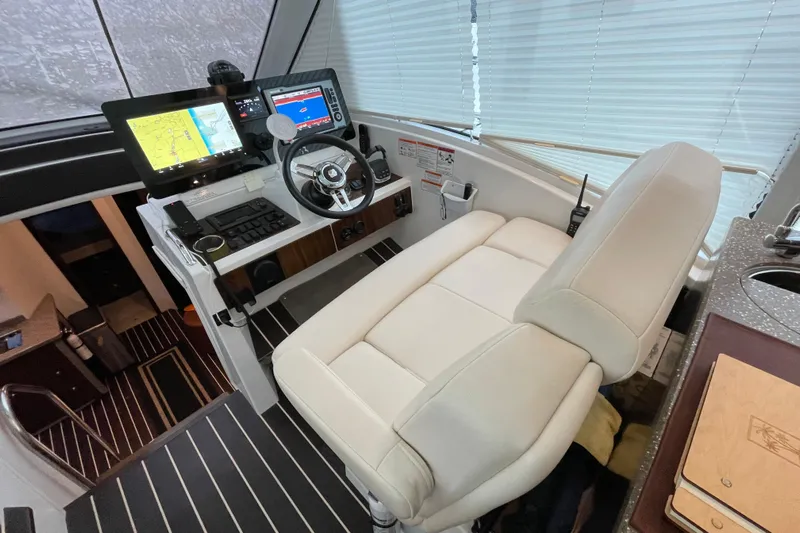 Plan B Yacht Photos Pics Helm station of 2012 Cruisers Yachts 48 Cantius with modern navigation equipment.