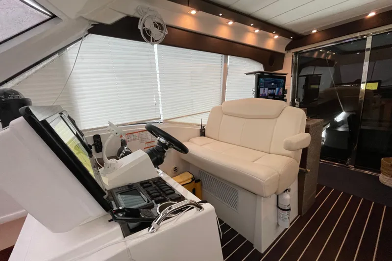 Plan B Yacht Photos Pics Interior helm of 2012 Cruisers Yachts 48 Cantius with modern controls and seating.