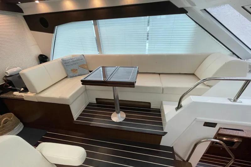 Plan B Yacht Photos Pics Luxurious interior of 2012 Cruisers Yachts 48 Cantius with elegant seating and table.