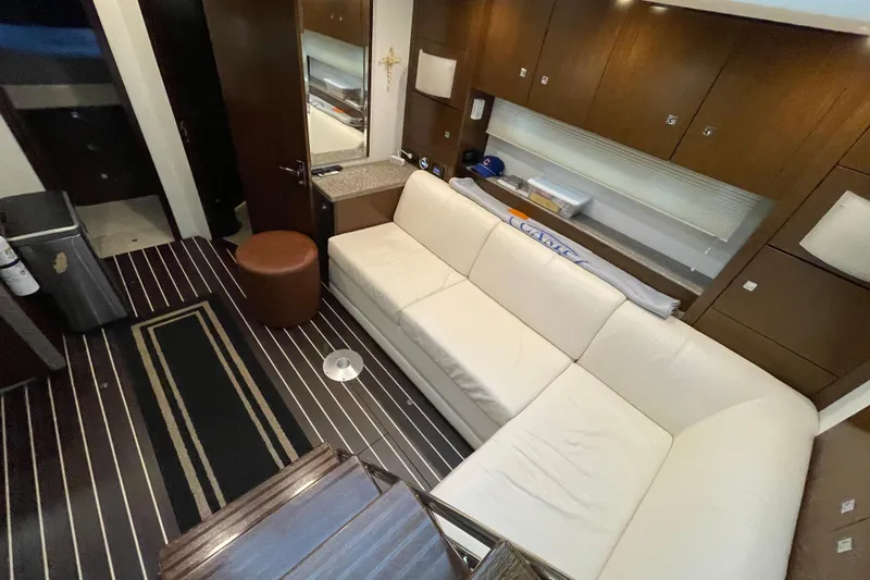 Plan B Yacht Photos Pics Luxurious interior of 2012 Cruisers Yachts 48 Cantius with white sofa and wooden accents.