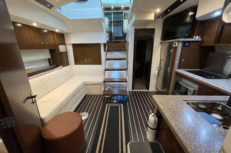 Plan B Yacht Photos Pics Luxurious interior of 2012 Cruisers Yachts 48 Cantius with modern kitchen and seating area.