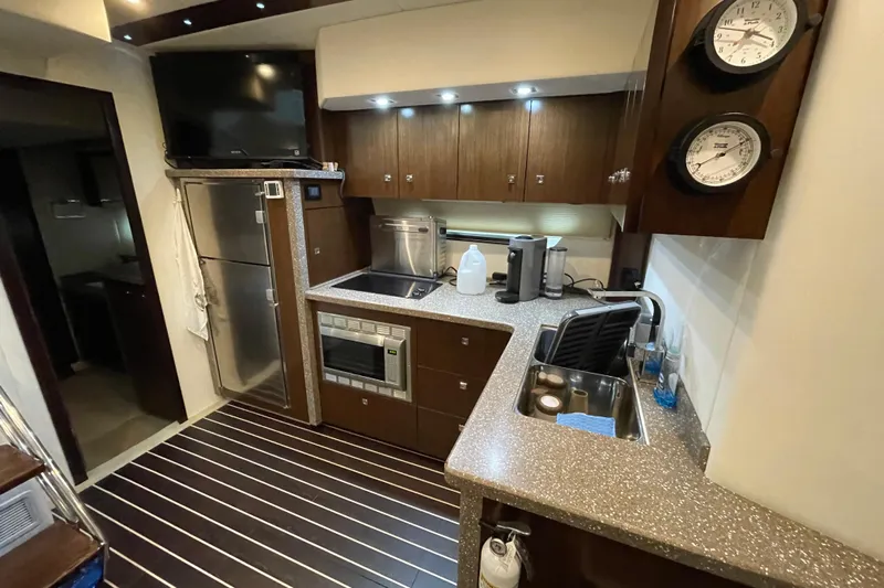 Plan B Yacht Photos Pics Luxurious 2012 Cruisers Yachts 48 Cantius kitchen with modern appliances and sleek design.
