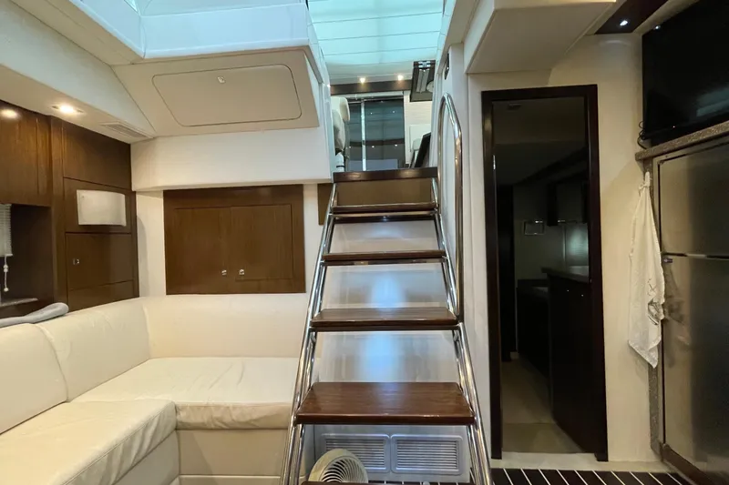 Plan B Yacht Photos Pics Interior of 2012 Cruisers Yachts 48 Cantius with modern staircase and seating area.