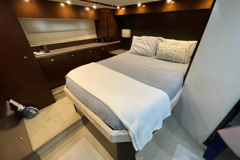 Plan B Yacht Photos Pics Luxurious bedroom interior of 2012 Cruisers Yachts 48 Cantius with elegant bedding and ambient lighting.