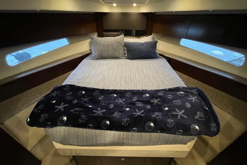 Plan B Yacht Photos Pics Luxurious 2012 Cruisers Yachts 48 Cantius bedroom with elegant bedding and ambient lighting.