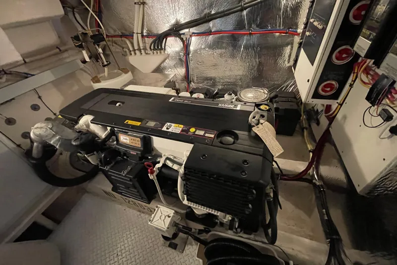 Plan B Yacht Photos Pics Engine room of 2012 Cruisers Yachts 48 Cantius, showcasing mechanical components and wiring.