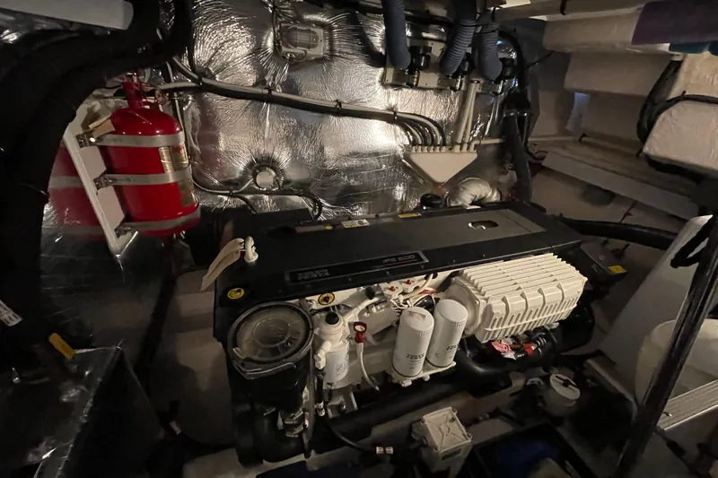 Plan B Yacht Photos Pics Engine room of 2012 Cruisers Yachts 48 Cantius with fire extinguisher and mechanical components.