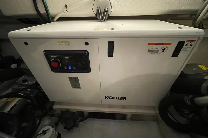 Plan B Yacht Photos Pics Kohler generator in 2012 Cruisers Yachts 48 Cantius engine room, showcasing control panel.