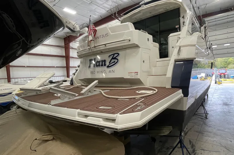 Plan B Yacht Photos Pics 2012 Cruisers Yachts 48 Cantius in storage, featuring a spacious deck and elegant design.