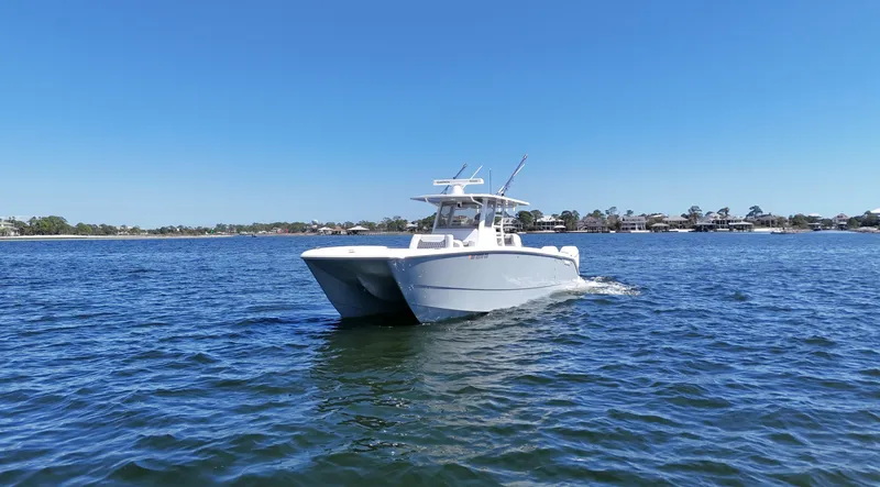 Engine Warranty Yacht Photos Pics 2020 Invincible 37 Catamaran cruising on open water under clear blue sky.