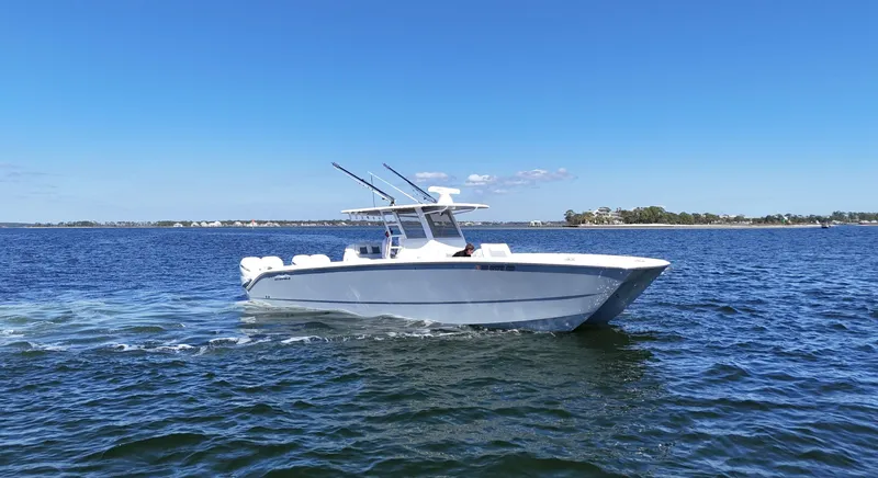 Engine Warranty Yacht Photos Pics 2020 Invincible 37 Catamaran cruising on open water under clear blue skies.