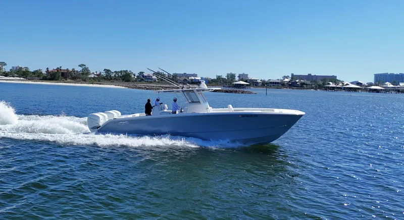 Engine Warranty Yacht Photos Pics 2020 Invincible 37 Catamaran cruising on a sunny day near the shoreline.