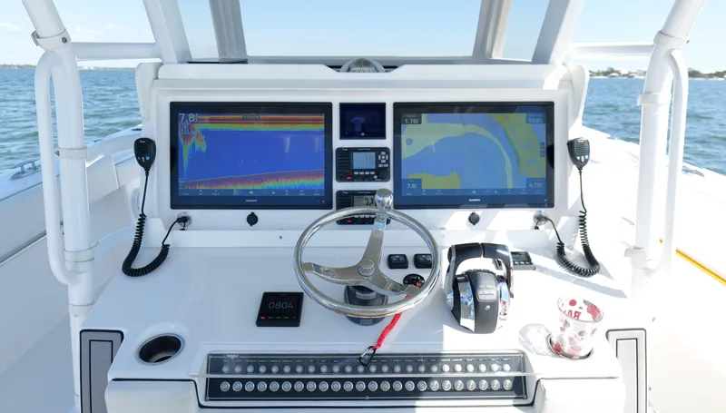 Engine Warranty Yacht Photos Pics Control panel of 2020 Invincible 37 Catamaran with dual navigation screens and steering wheel.