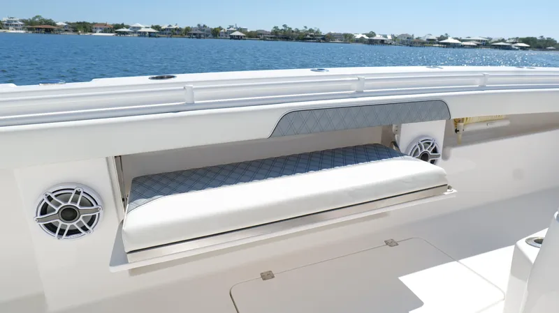 Engine Warranty Yacht Photos Pics Invincible 37 Catamaran 2020, featuring a cushioned seating area and speakers, on a sunny day.
