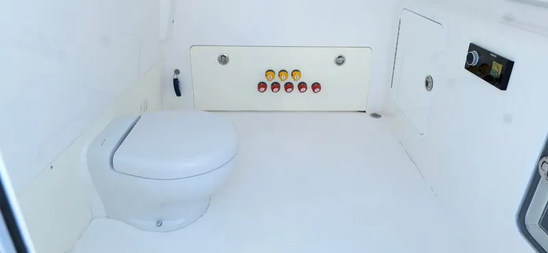 Engine Warranty Yacht Photos Pics Interior of 2020 Invincible 37 Catamaran showing a compact marine toilet setup.