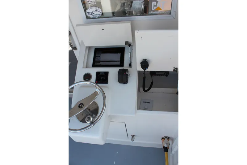 Miss Jennie Yacht Photos Pics Helm of 2008 H&H Marine 38 boat with steering wheel and navigation equipment.