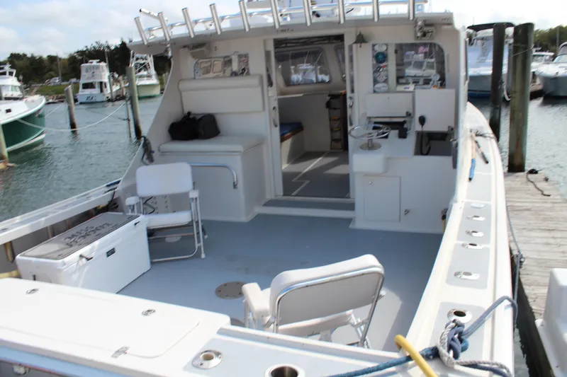 Miss Jennie Yacht Photos Pics 2008 H&H Marine 38 boat docked, featuring spacious deck and seating area.