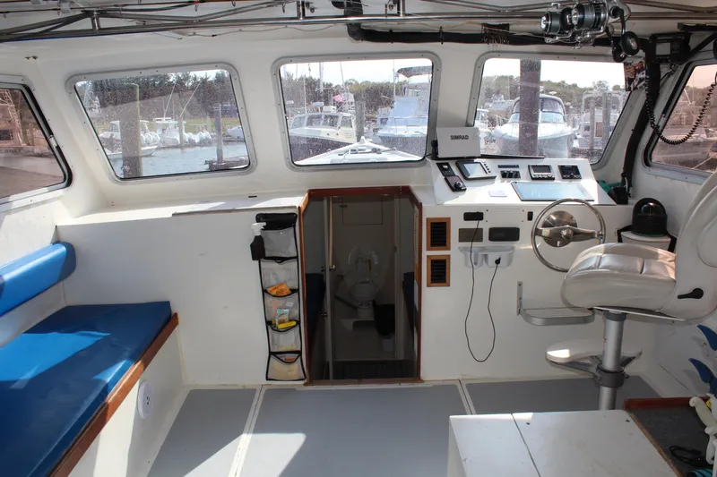 Miss Jennie Yacht Photos Pics Interior of 2008 H&H Marine 38 boat with helm, seating, and equipment.