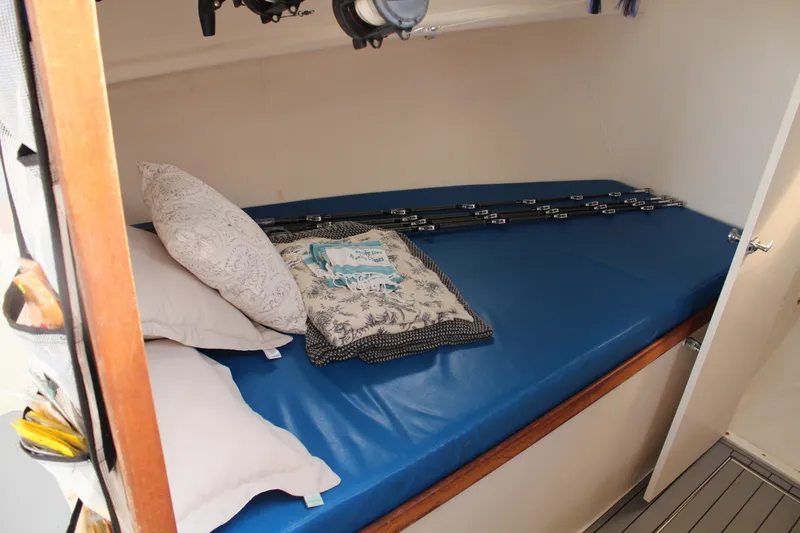 Miss Jennie Yacht Photos Pics Cozy cabin interior of 2008 H&H Marine 38 with blue mattress and pillows.