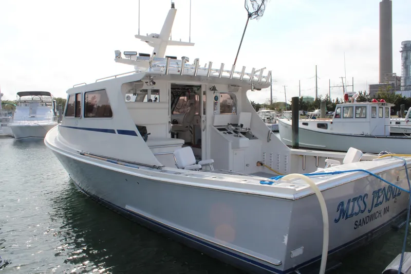 Miss Jennie Yacht Photos Pics 2008 H&H Marine 38 boat docked, featuring open deck and fishing equipment, named "Miss Jennifer."