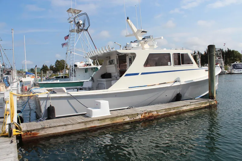 Miss Jennie Yacht Photos Pics 2008 H&H Marine 38 boat docked at a marina under a clear blue sky.